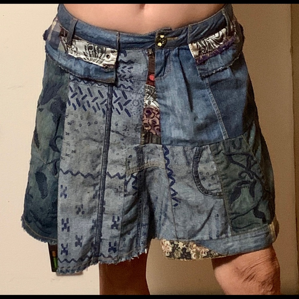 Distressed, patchy denim mini skirt